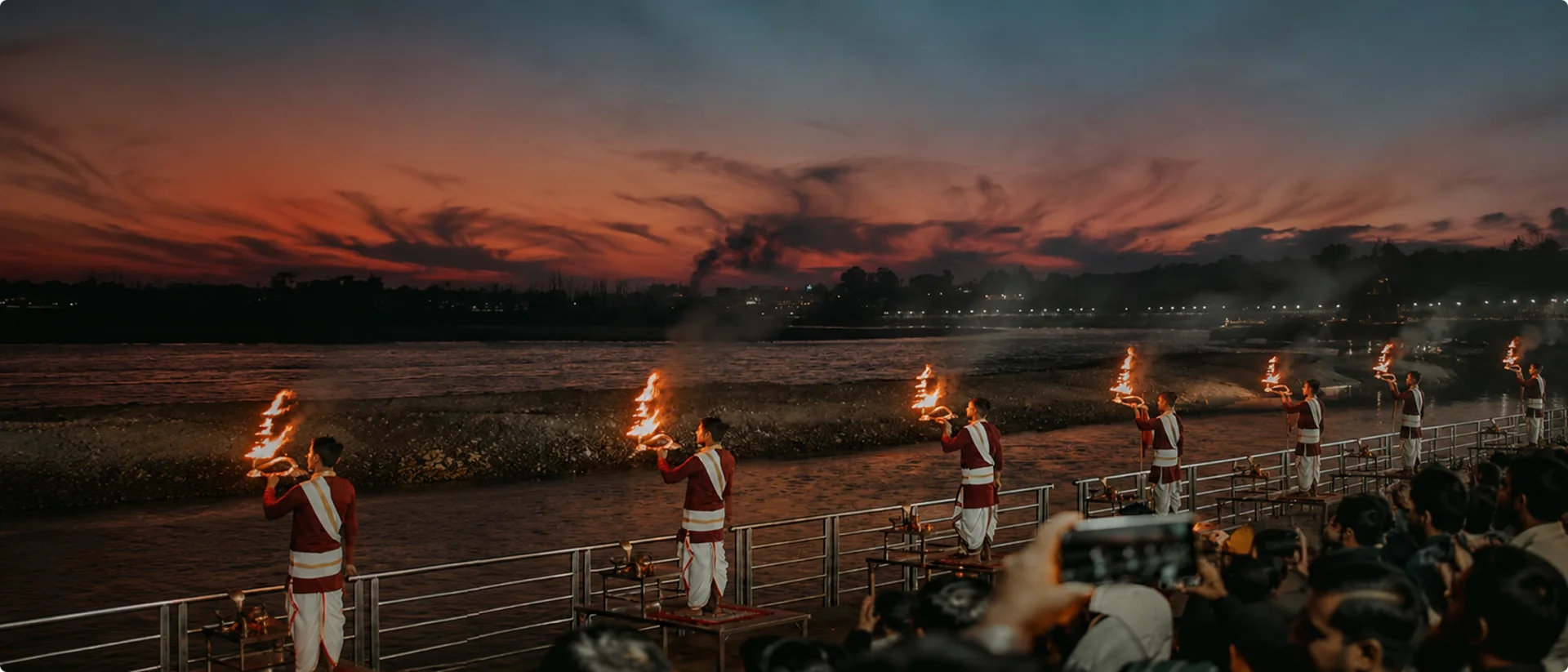 Traditional Ganga Aarti fire ritual at sunset by the river